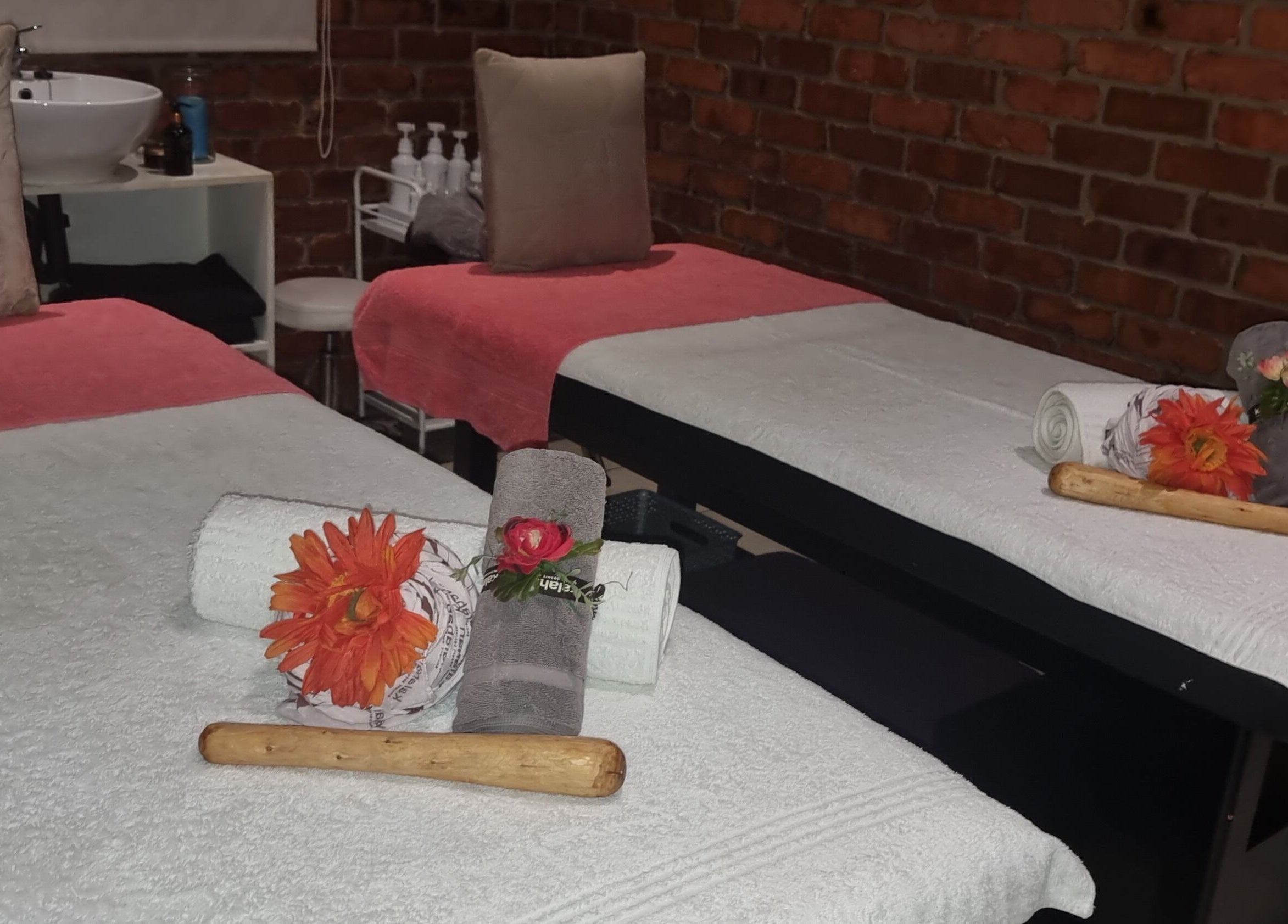 Relaxing massage room at Zoella Day Spa, Bela-Bela, Limpopo, ZA with cozy twin tables and rolled towels.