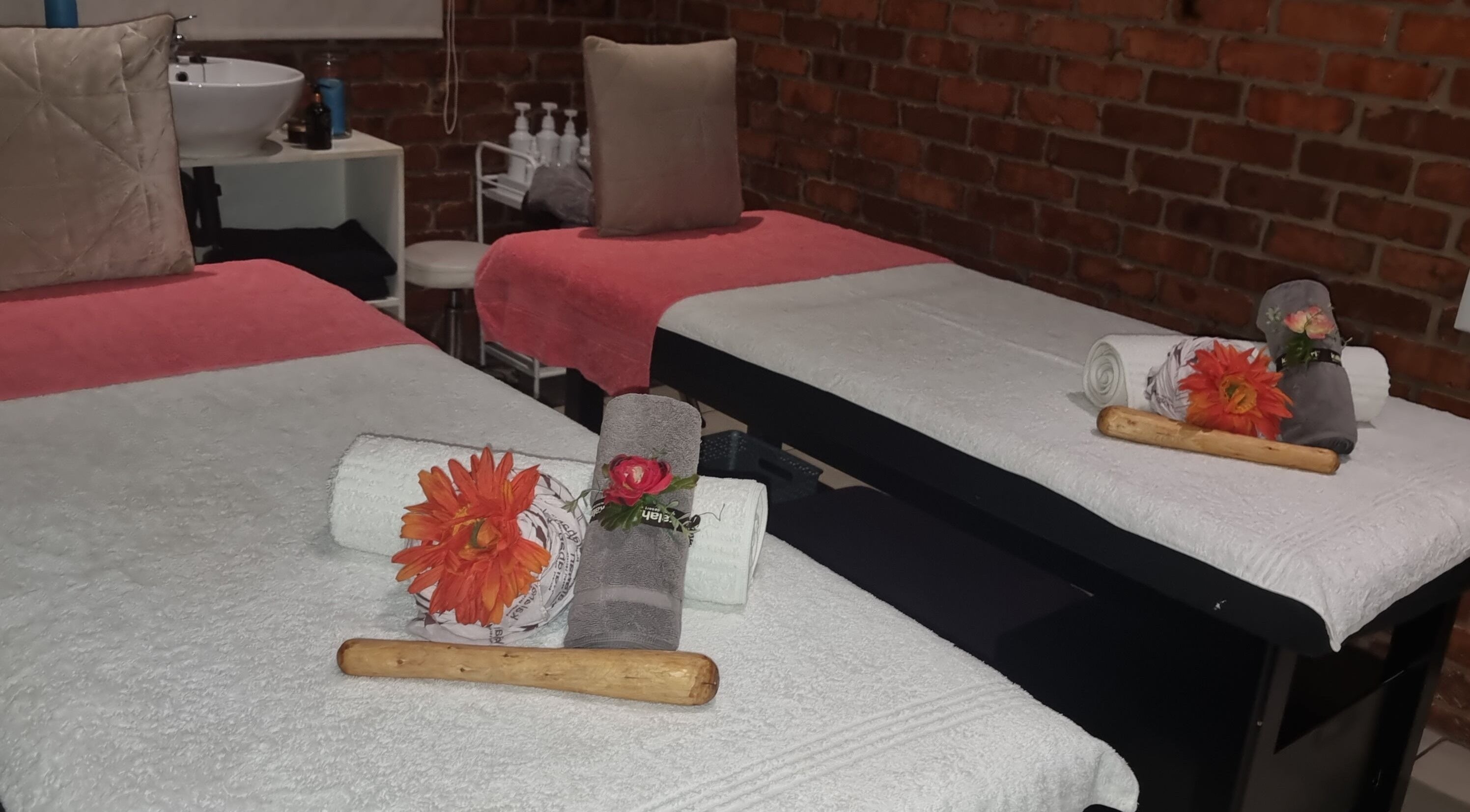 Relaxing massage room at Zoella Day Spa, Bela-Bela, Limpopo, ZA with cozy twin tables and rolled towels.