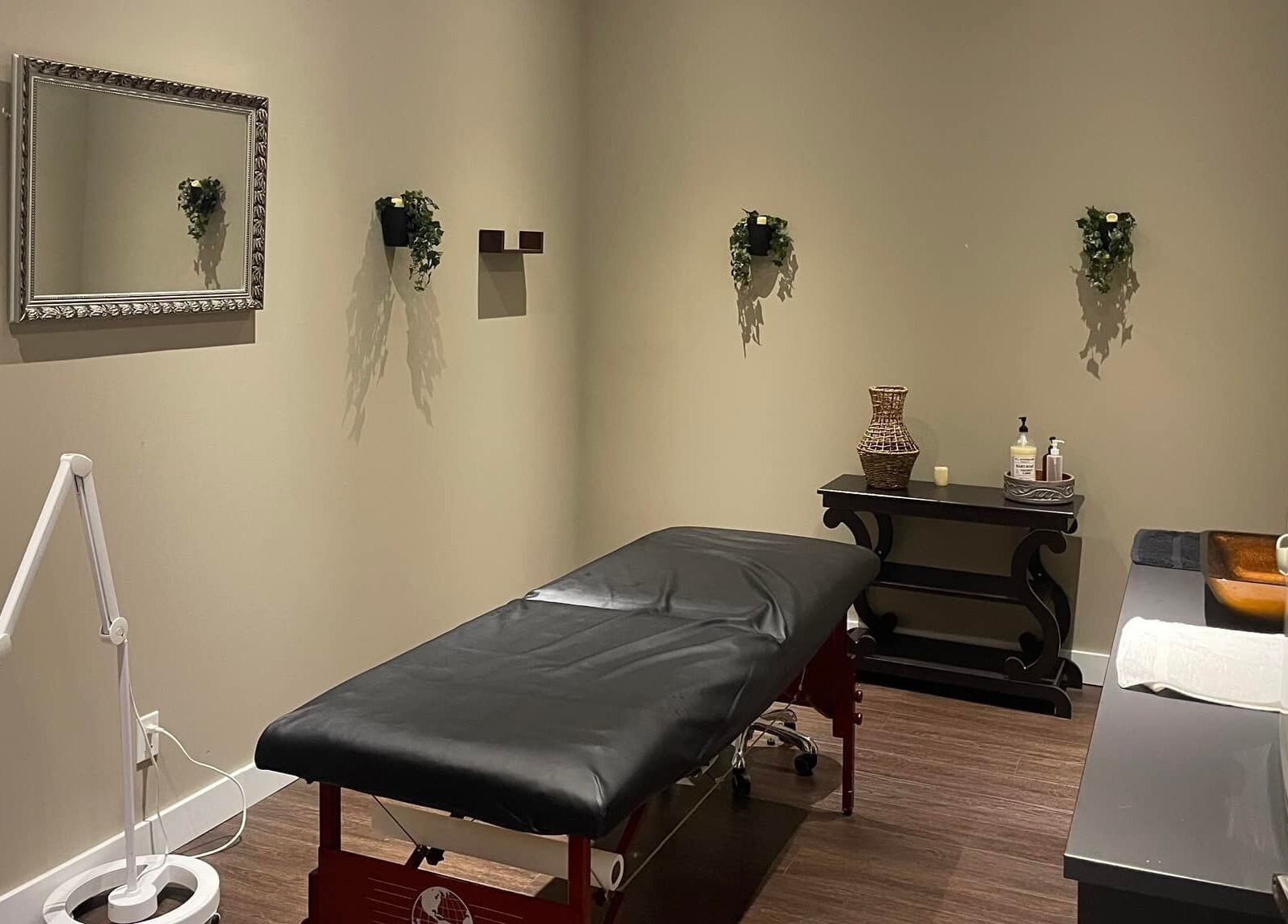 Elegant treatment room with a massage table at Nurse Cori Injectables & Aesthetics, Milton, Ontario, CA.