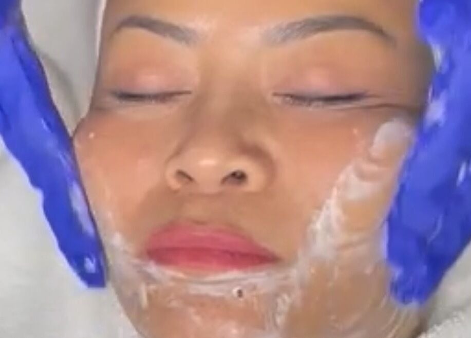 Facial treatment at Nurse Cori Injectables & Aesthetics, Milton, Ontario, CA. Gloved hands applying cream.