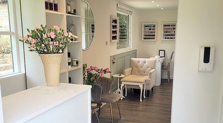 Welcoming interior of VG Beauty in Ilkley, England, GB featuring elegant seating and floral decor.
