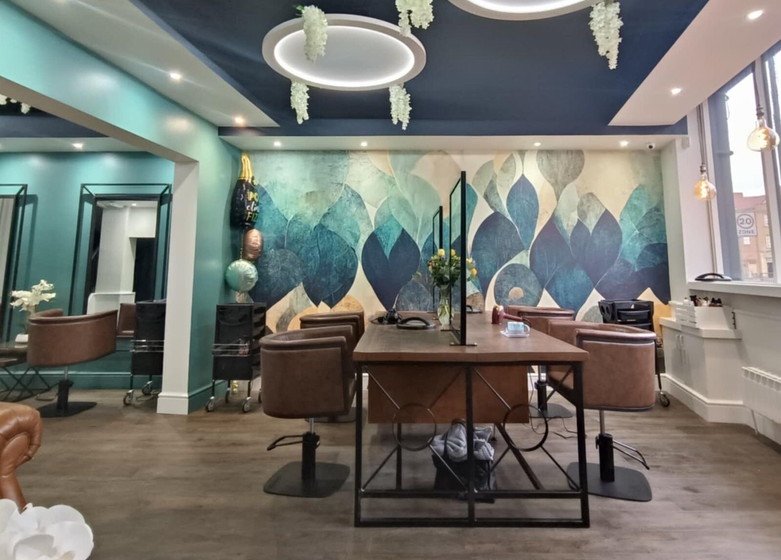 Chic interior of KaKoon in Selby, England, GB with teal walls, stylish chairs, and artistic mural.