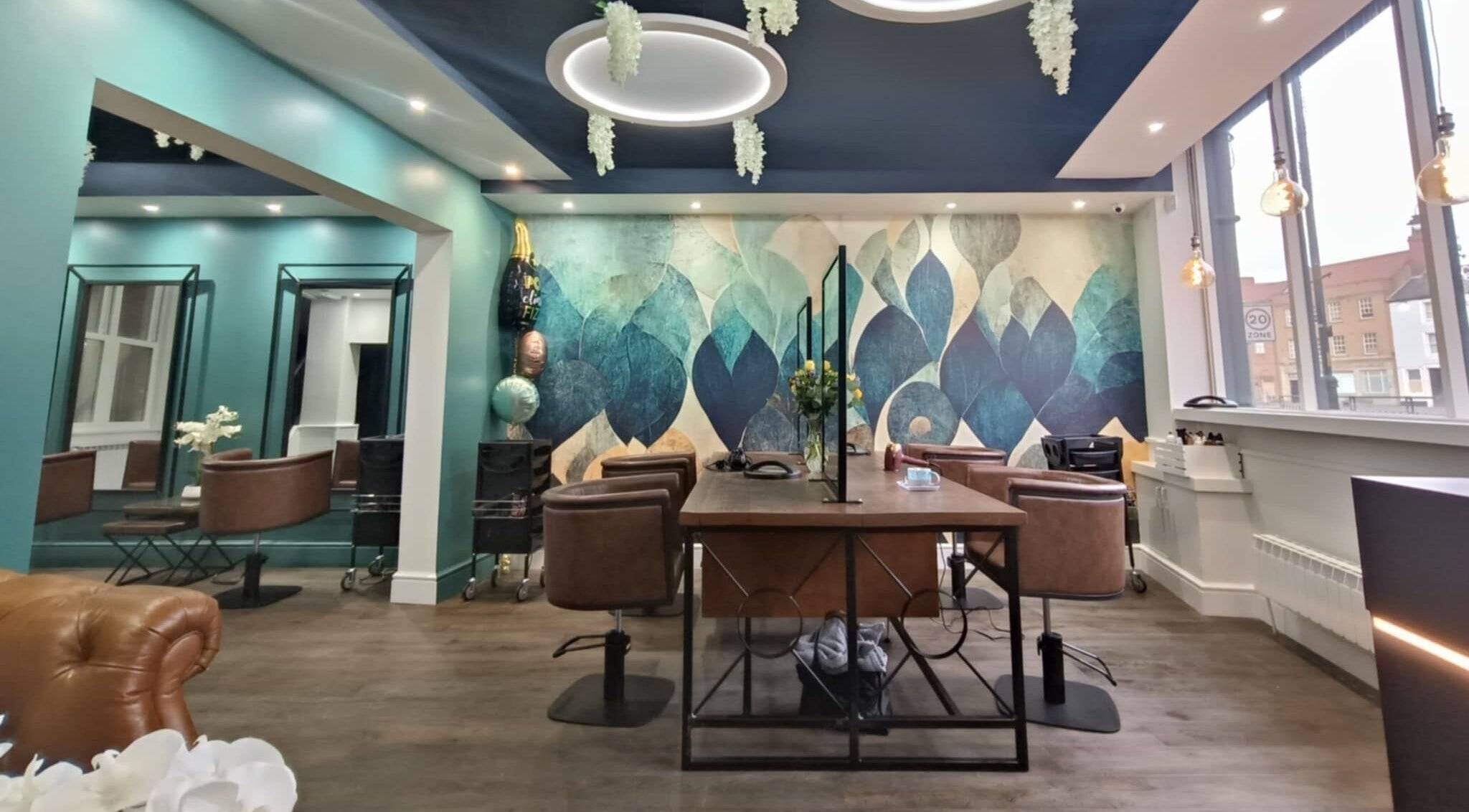 Chic interior of KaKoon in Selby, England, GB with teal walls, stylish chairs, and artistic mural.