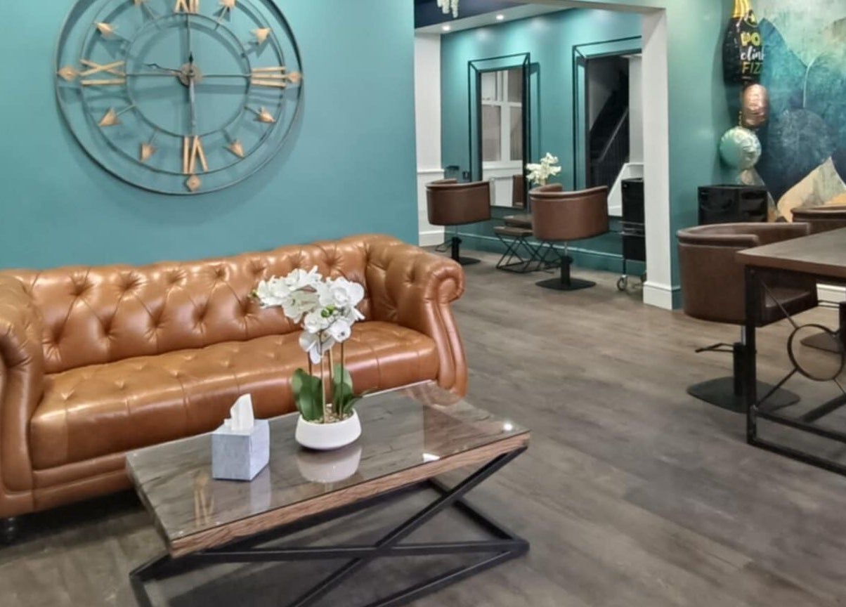 Chic waiting area at KaKoon, Selby, England, GB, featuring a brown leather sofa and stylish decor.