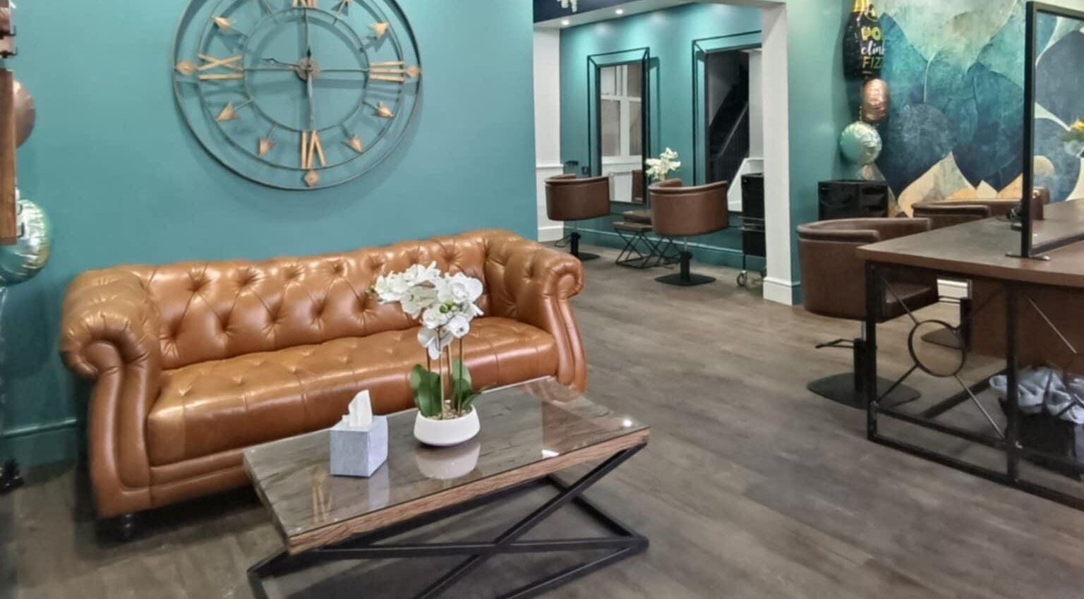Chic waiting area at KaKoon, Selby, England, GB, featuring a brown leather sofa and stylish decor.