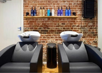 Chic salon wash stations at The Ultimate Touch, Wymondham, England, GB, featuring sleek design and high-quality products.