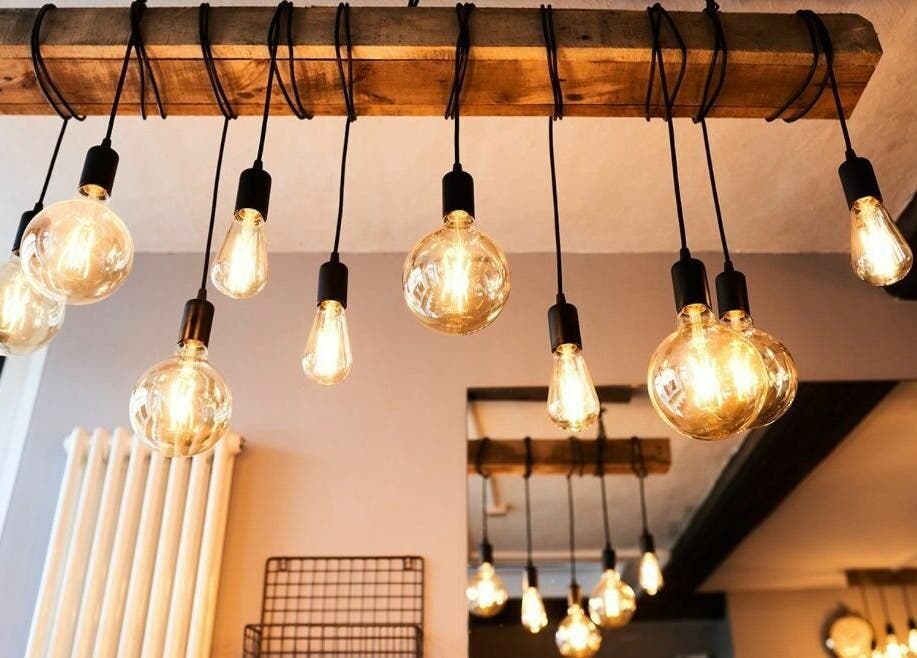 Elegant hanging light bulbs at The Ultimate Touch, Wymondham, England, GB, illuminate the cozy interior.