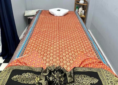 Massage table at Narree Thai Massage & Spa, Wingham, New South Wales, AU with traditional Thai decor.