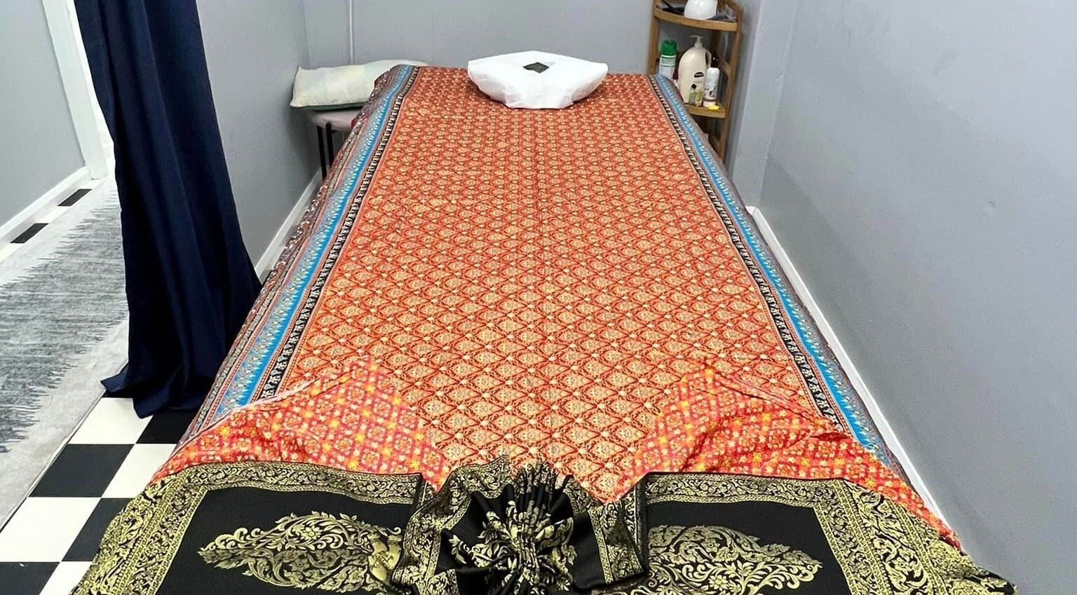 Massage table at Narree Thai Massage & Spa, Wingham, New South Wales, AU with traditional Thai decor.