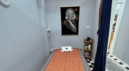Tranquil therapy room at Narree Thai Massage & Spa in Wingham, New South Wales, AU, featuring a massage bed and artwork.
