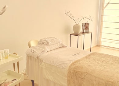 Calming treatment room at Victoria Skin Clinic, Melbourne, Victoria, AU, with spa bed and skincare products.