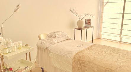 Calming treatment room at Victoria Skin Clinic, Melbourne, Victoria, AU, with spa bed and skincare products.