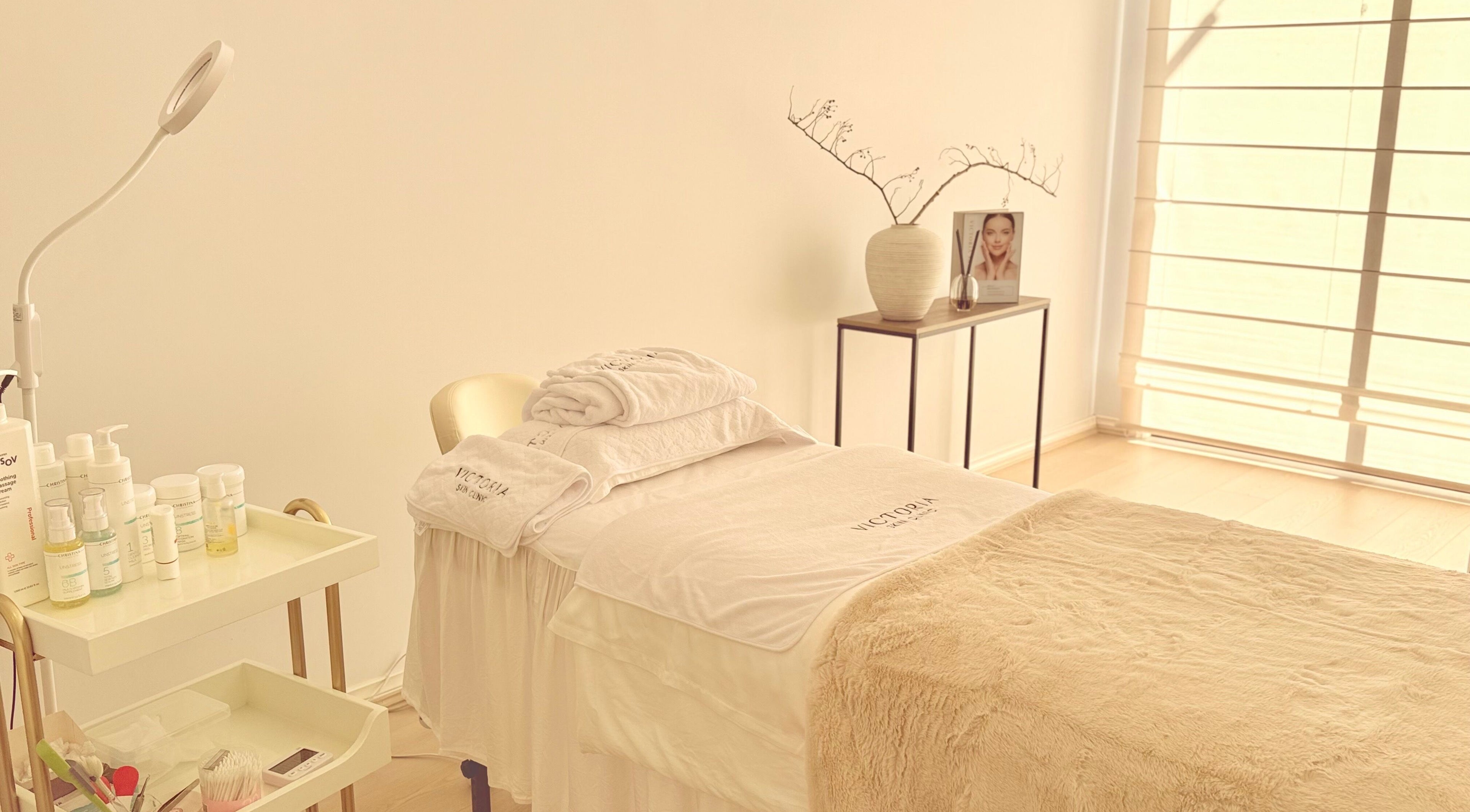 Calming treatment room at Victoria Skin Clinic, Melbourne, Victoria, AU, with spa bed and skincare products.