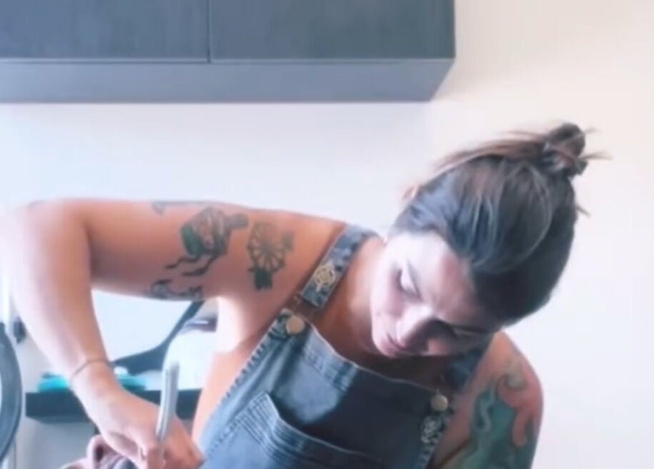 Tattooed stylist at work in LFG Styling by Lauren, Los Angeles, California, US.