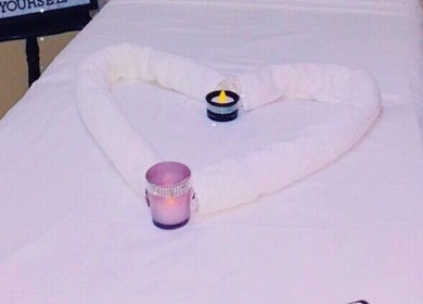 Elegant heart-shaped towel arrangement with candles at Spa D’amour, Oistins, Christ Church, BB.