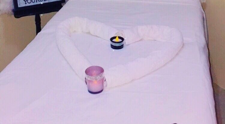 Relaxing massage table setup with towels and candles at Spa D’amour, Oistins, Christ Church, BB.