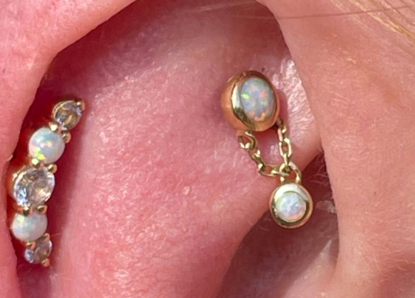 Stylish opal ear piercings at The Piercing Co, Bridgend, Wales, GB showcase elegance and craftsmanship.