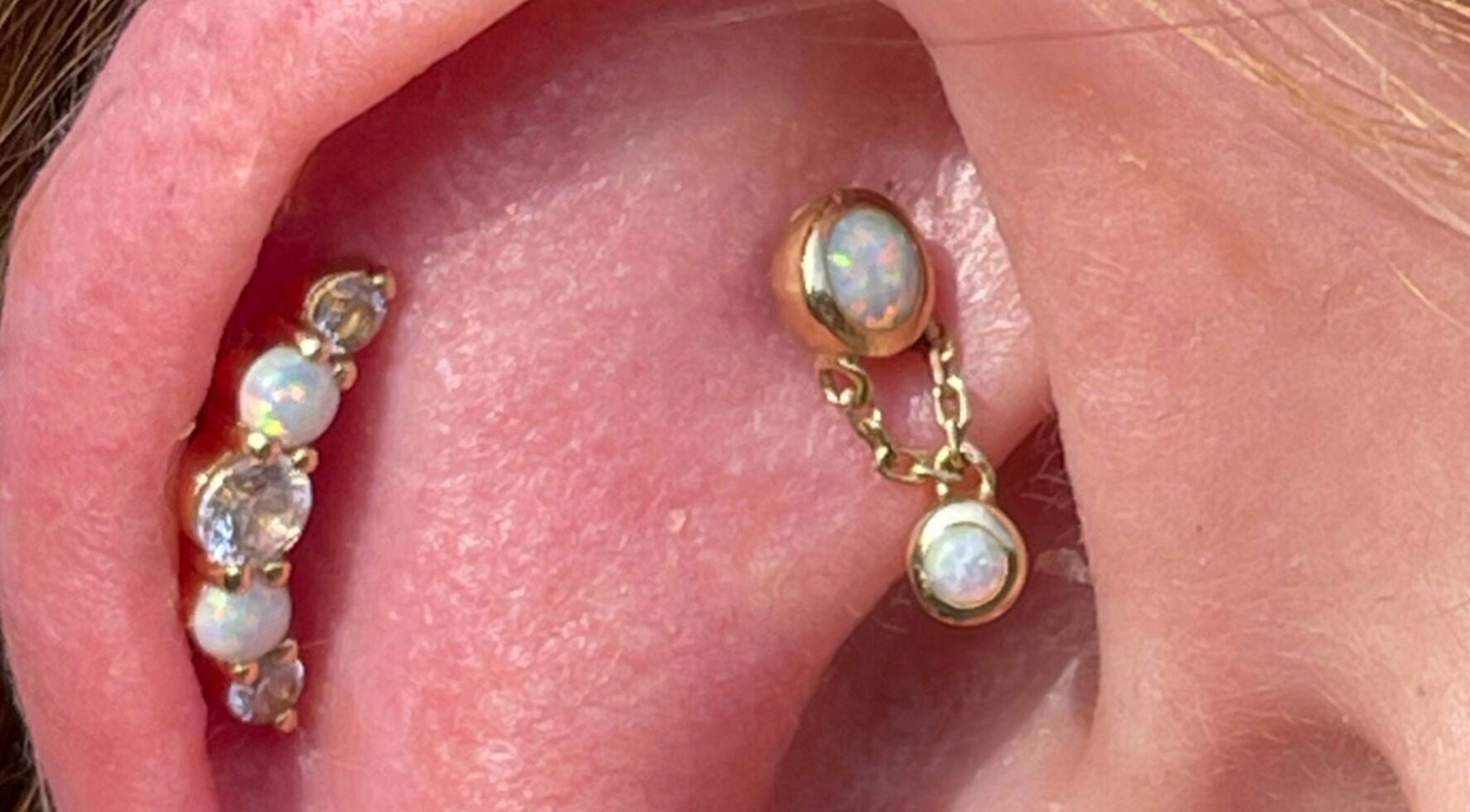 Stylish opal ear piercings at The Piercing Co, Bridgend, Wales, GB showcase elegance and craftsmanship.