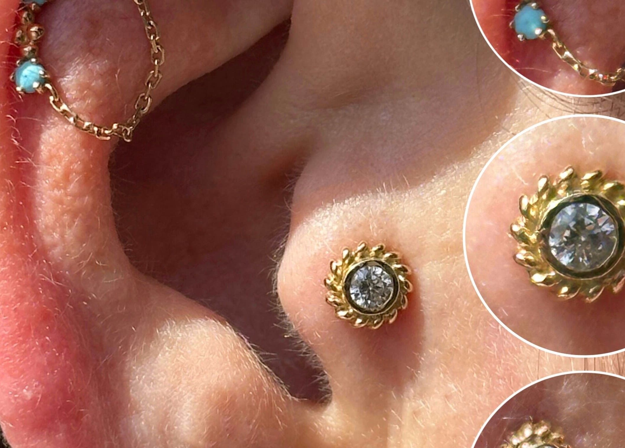 Close-up of elegant gold ear piercings at The Piercing Co, Bridgend, Wales, GB, featuring intricate designs.