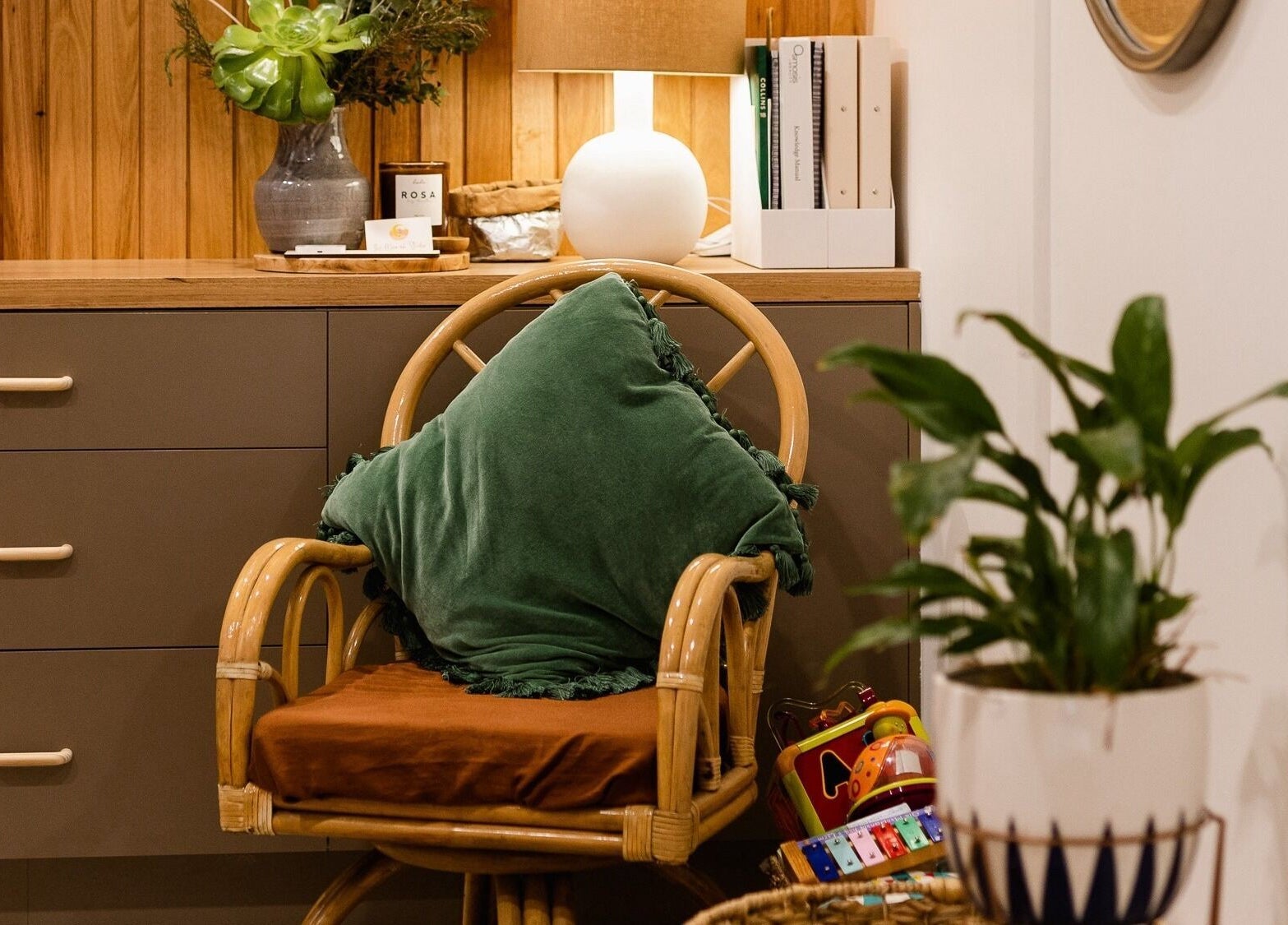 Cozy seating area at The Moonah Studio, Blairgowrie, Victoria, AU, featuring a plush chair and potted plant.