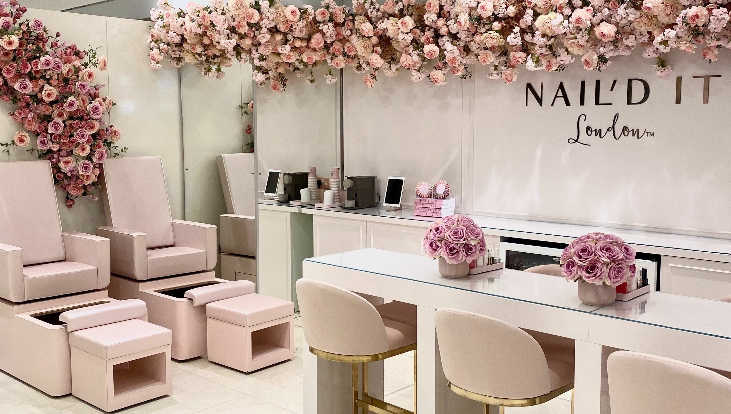Chic interior of Nail’d It x Harvey Nichols Edinburgh with soft pink seating and floral decor in Edinburgh, Scotland, GB.