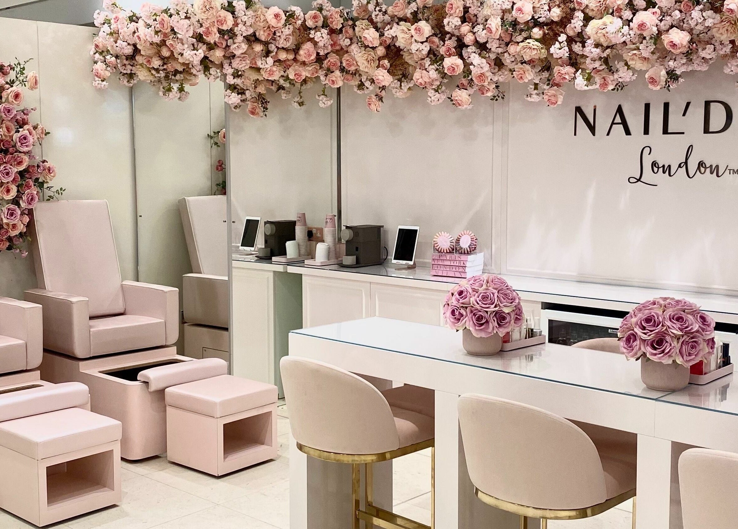 Chic interior of Nail’d It x Harvey Nichols Edinburgh with soft pink seating and floral decor in Edinburgh, Scotland, GB.