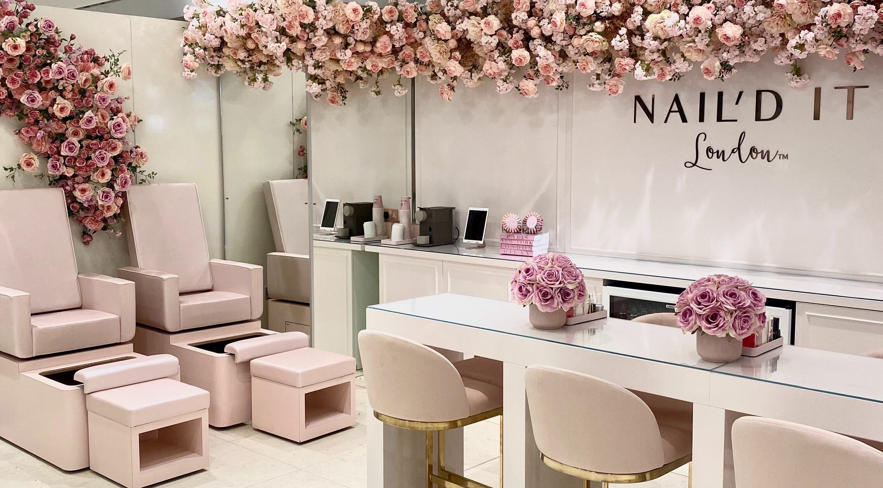 Chic interior of Nail’d It x Harvey Nichols Edinburgh with soft pink seating and floral decor in Edinburgh, Scotland, GB.