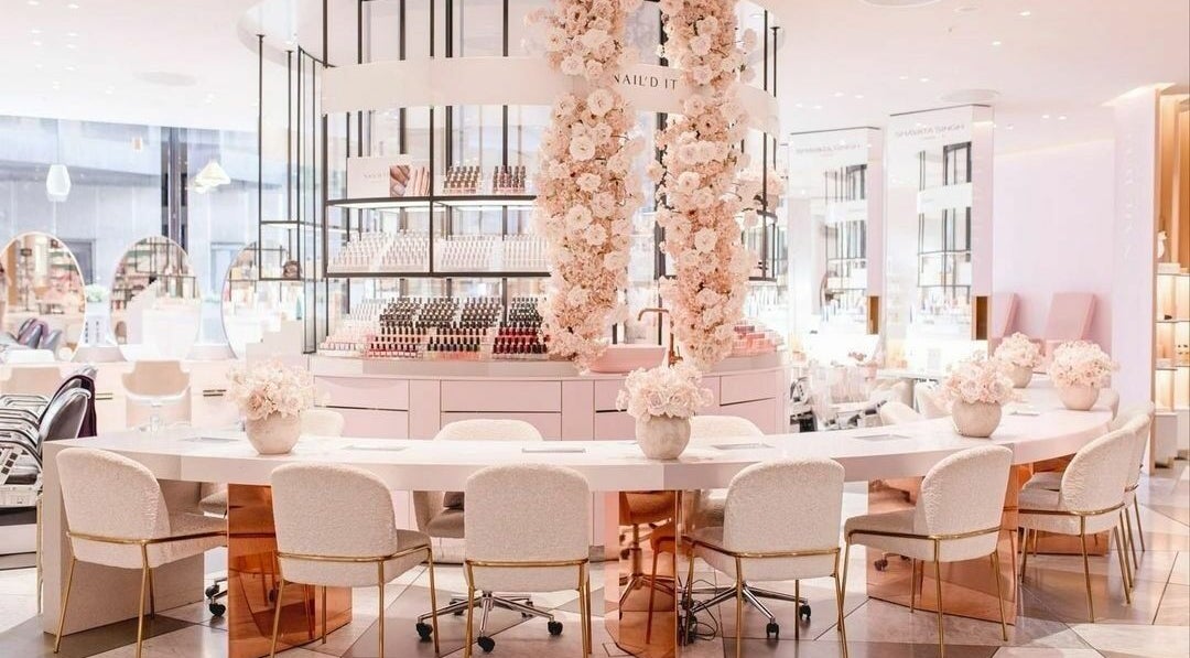 Chic interior of Nail’d It x Harvey Nichols Edinburgh in Edinburgh, Scotland, GB featuring plush seating and floral decor.