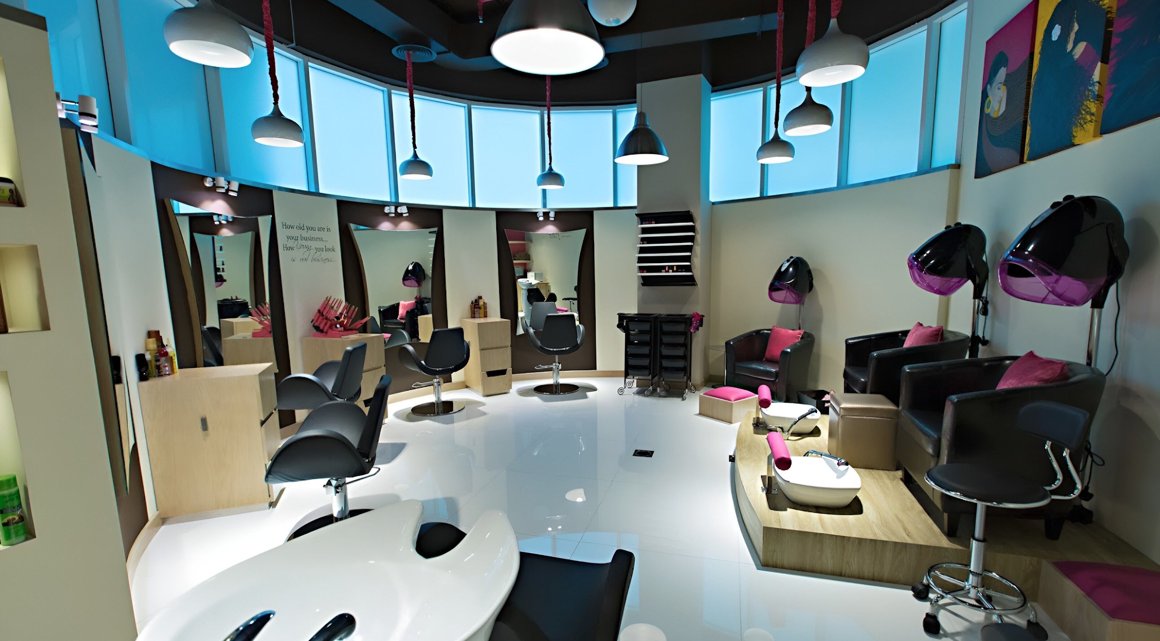 Elegant interior of Brown Sugar Hair Saloon in Dubai, AE, featuring modern styling chairs and hairdryers.