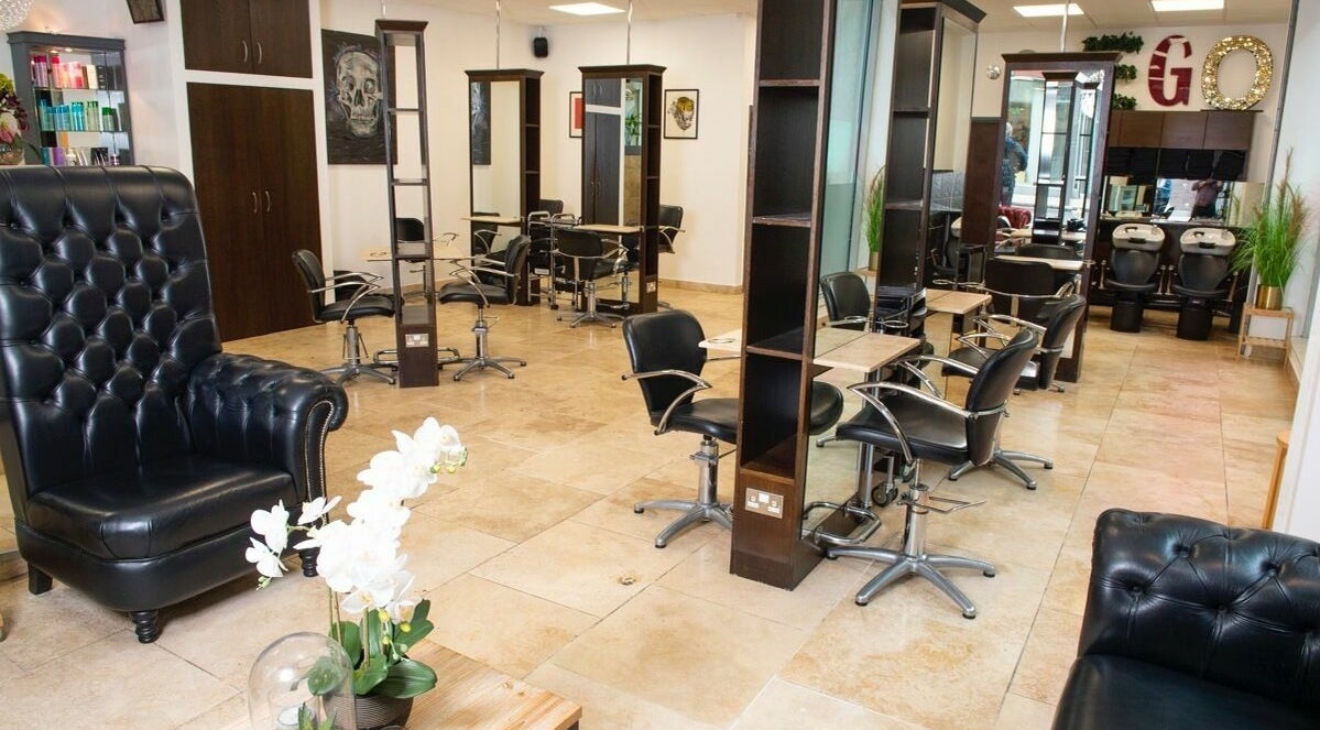 Sophisticated interior of Ego Hair Studio, Leeds, England, GB. Features chic black chairs and polished decor.
