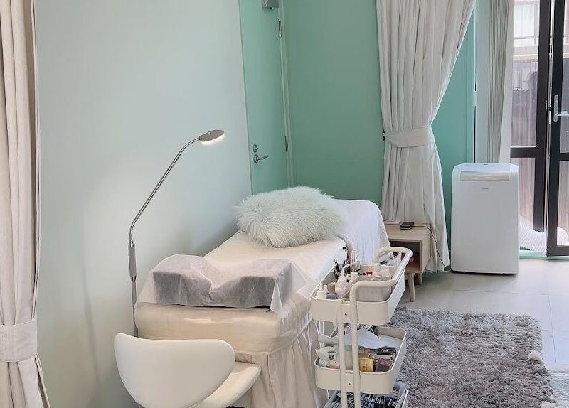 A tranquil beauty treatment room at Min Beauty, Auckland, Auckland, NZ with calming decor and a plush bed.