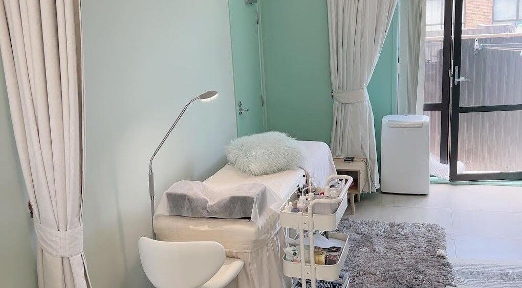 A tranquil beauty treatment room at Min Beauty, Auckland, Auckland, NZ with calming decor and a plush bed.