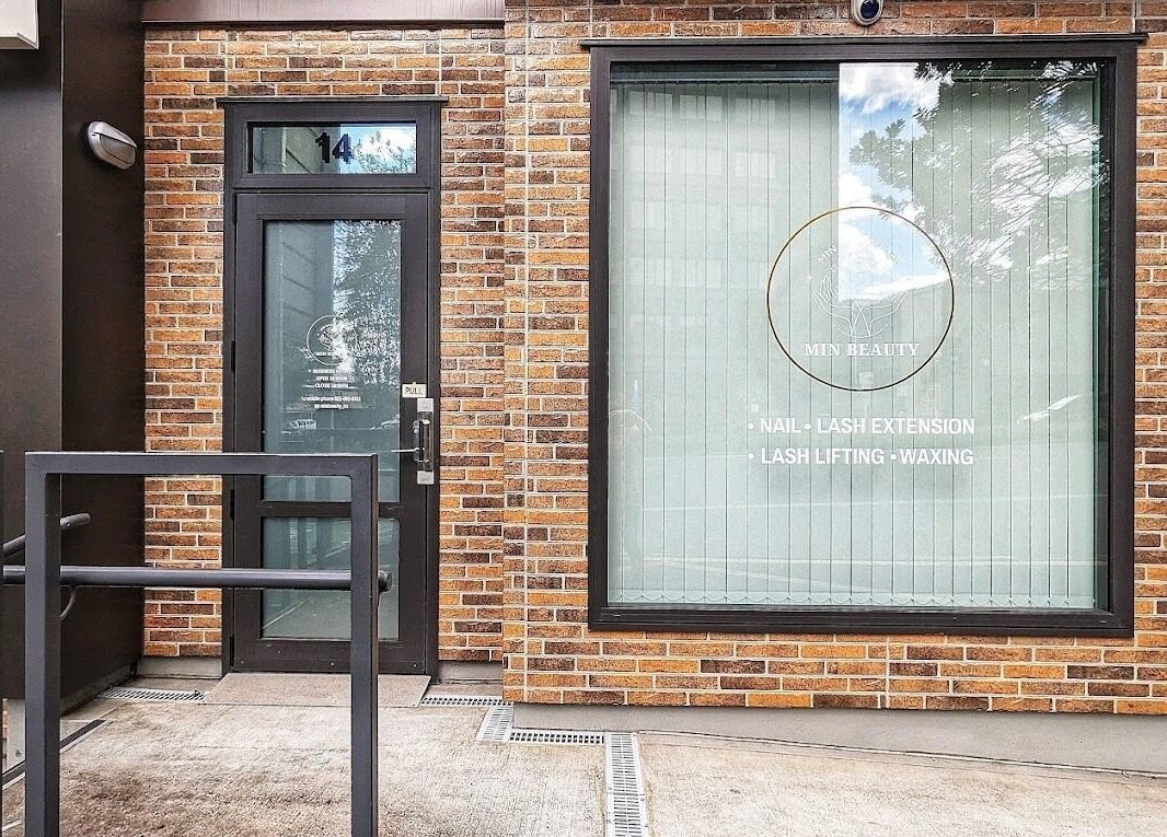 Front view of Min Beauty, located in Auckland, NZ. Features branding and services on brick exterior.