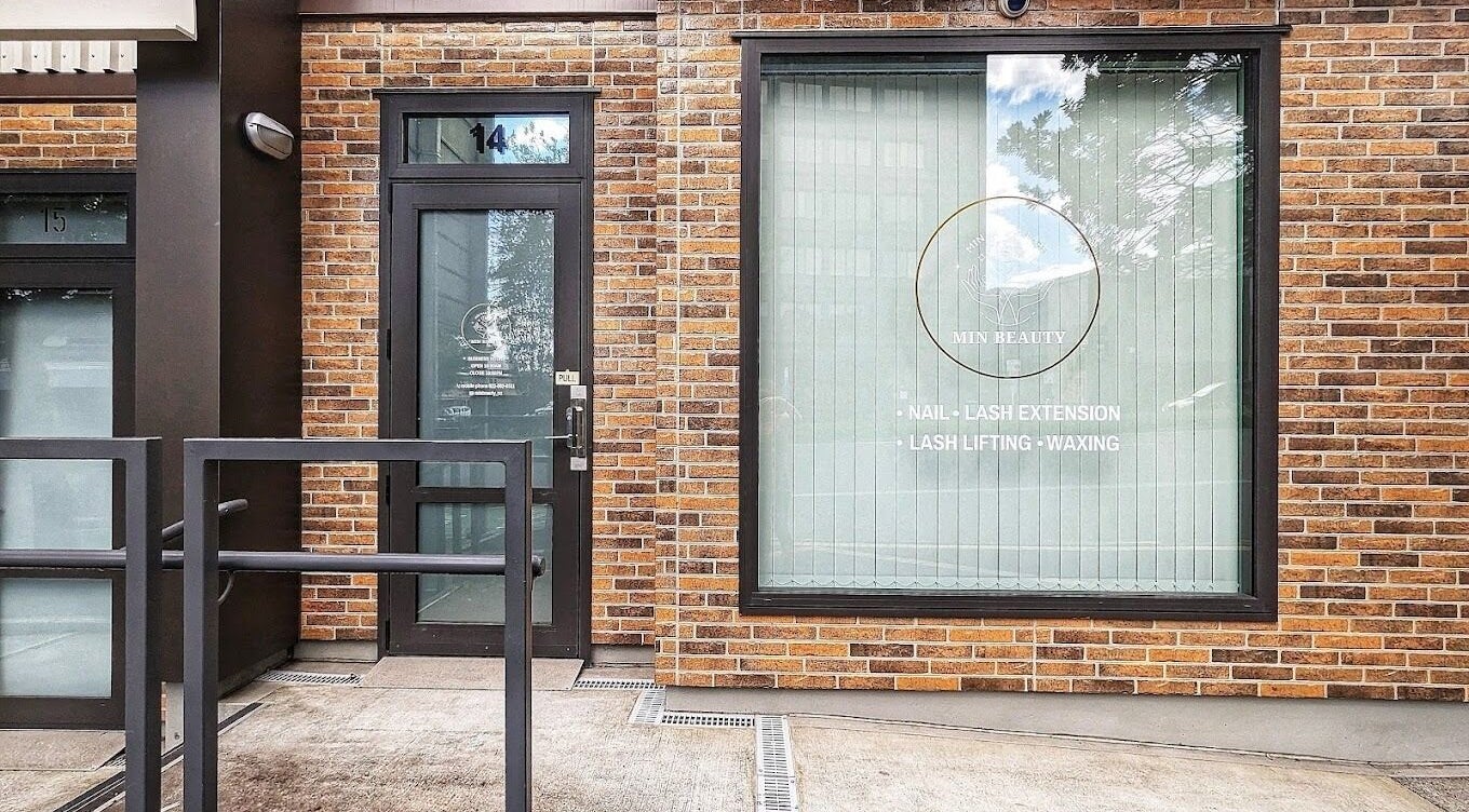 Front view of Min Beauty, located in Auckland, NZ. Features branding and services on brick exterior.