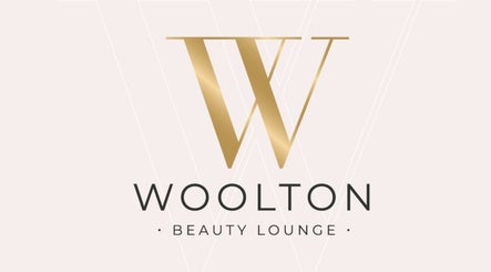 Elegant gold 'W' logo of Woolton Beauty Lounge, located in Liverpool, England, GB.