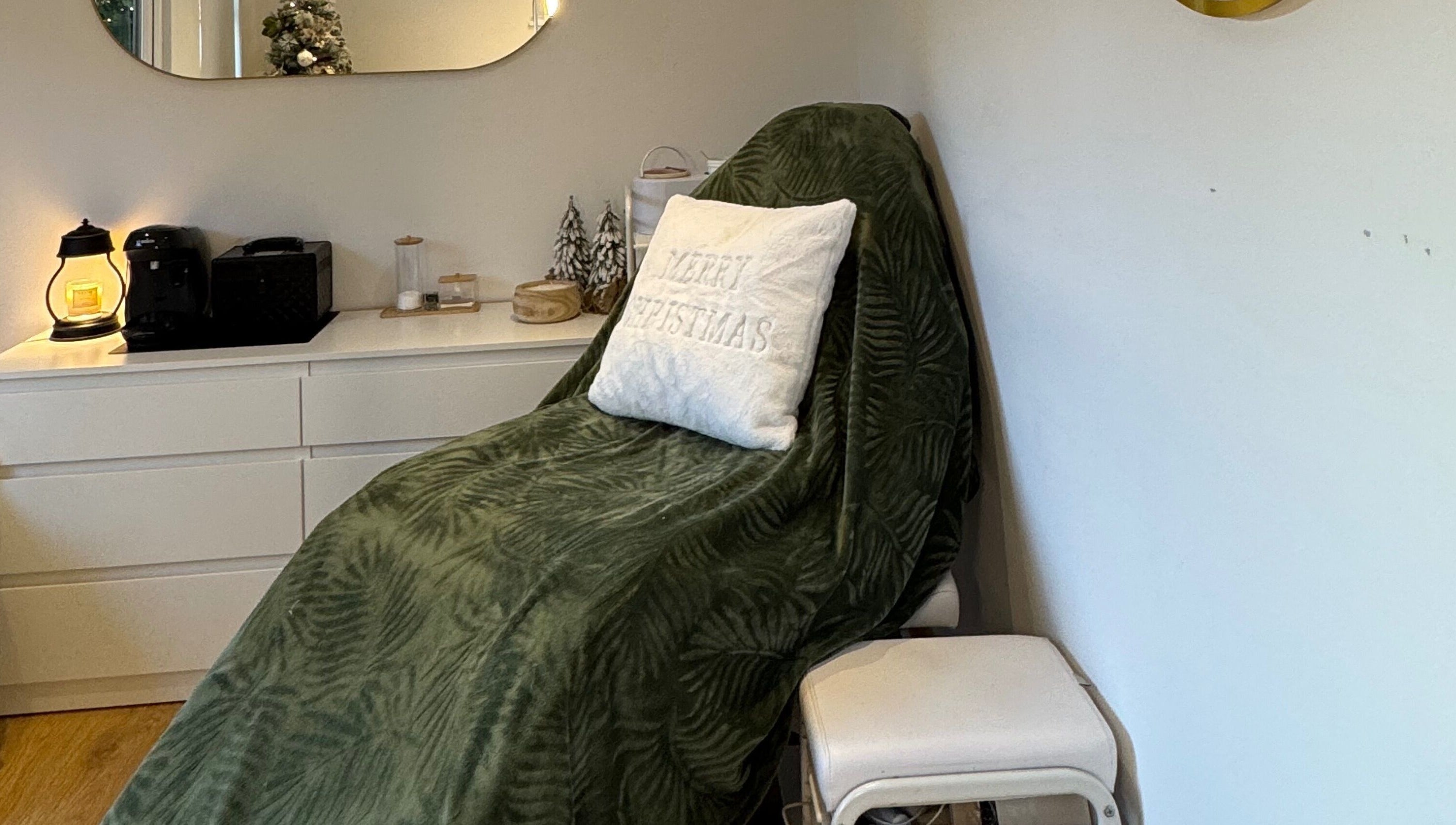Spa chair with green throw and Christmas themed decor at Woolton Beauty Lounge, Liverpool, England, GB.