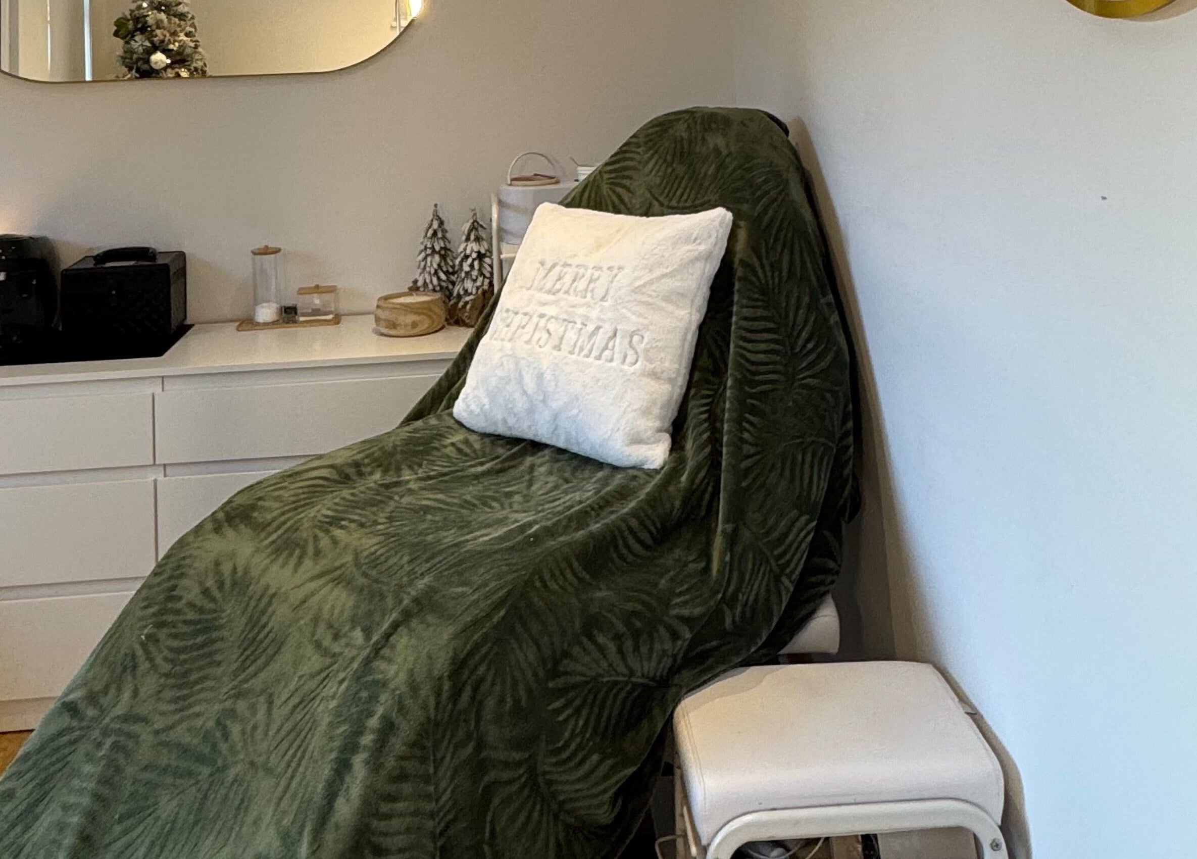 Spa chair with green throw and Christmas themed decor at Woolton Beauty Lounge, Liverpool, England, GB.