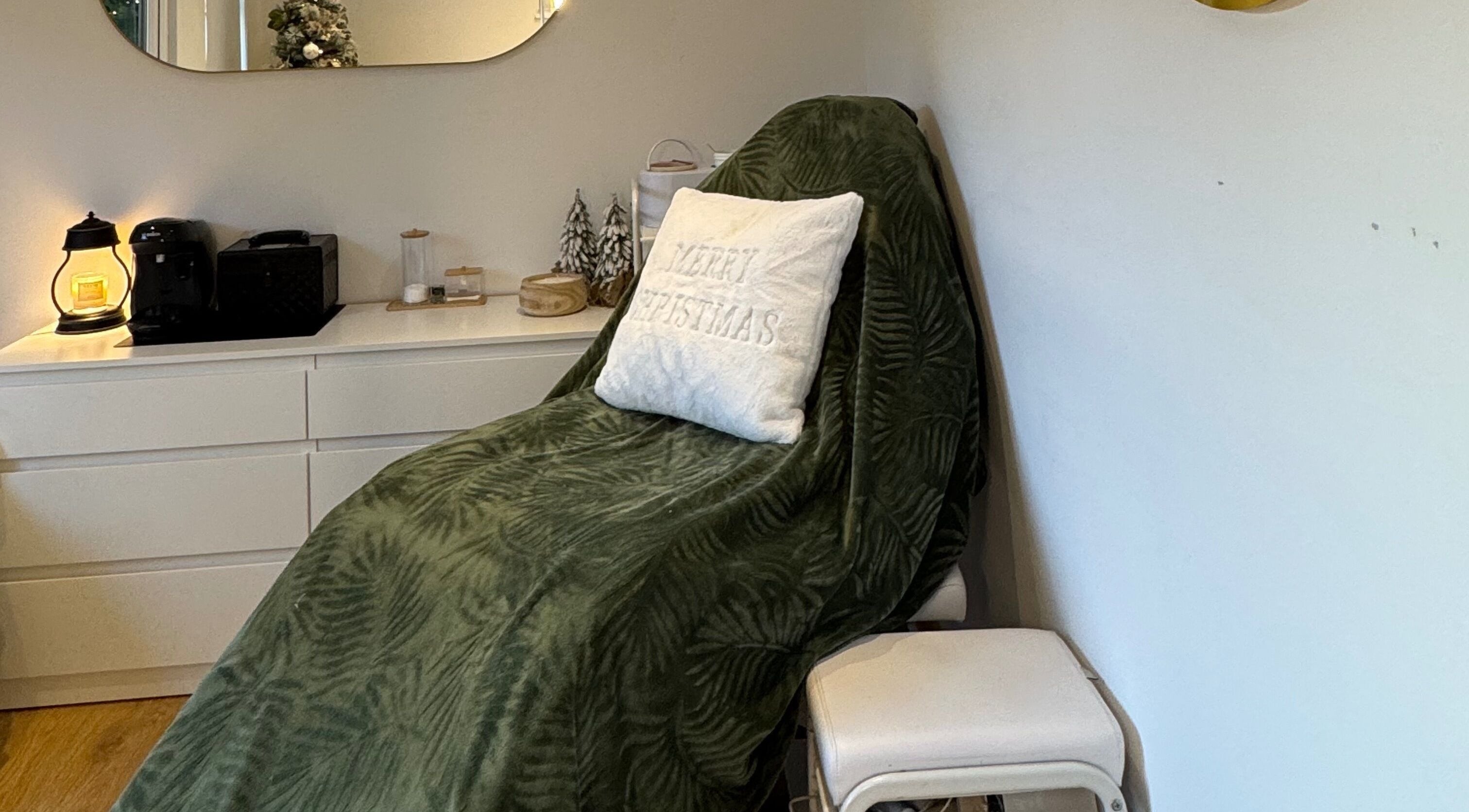 Spa chair with green throw and Christmas themed decor at Woolton Beauty Lounge, Liverpool, England, GB.