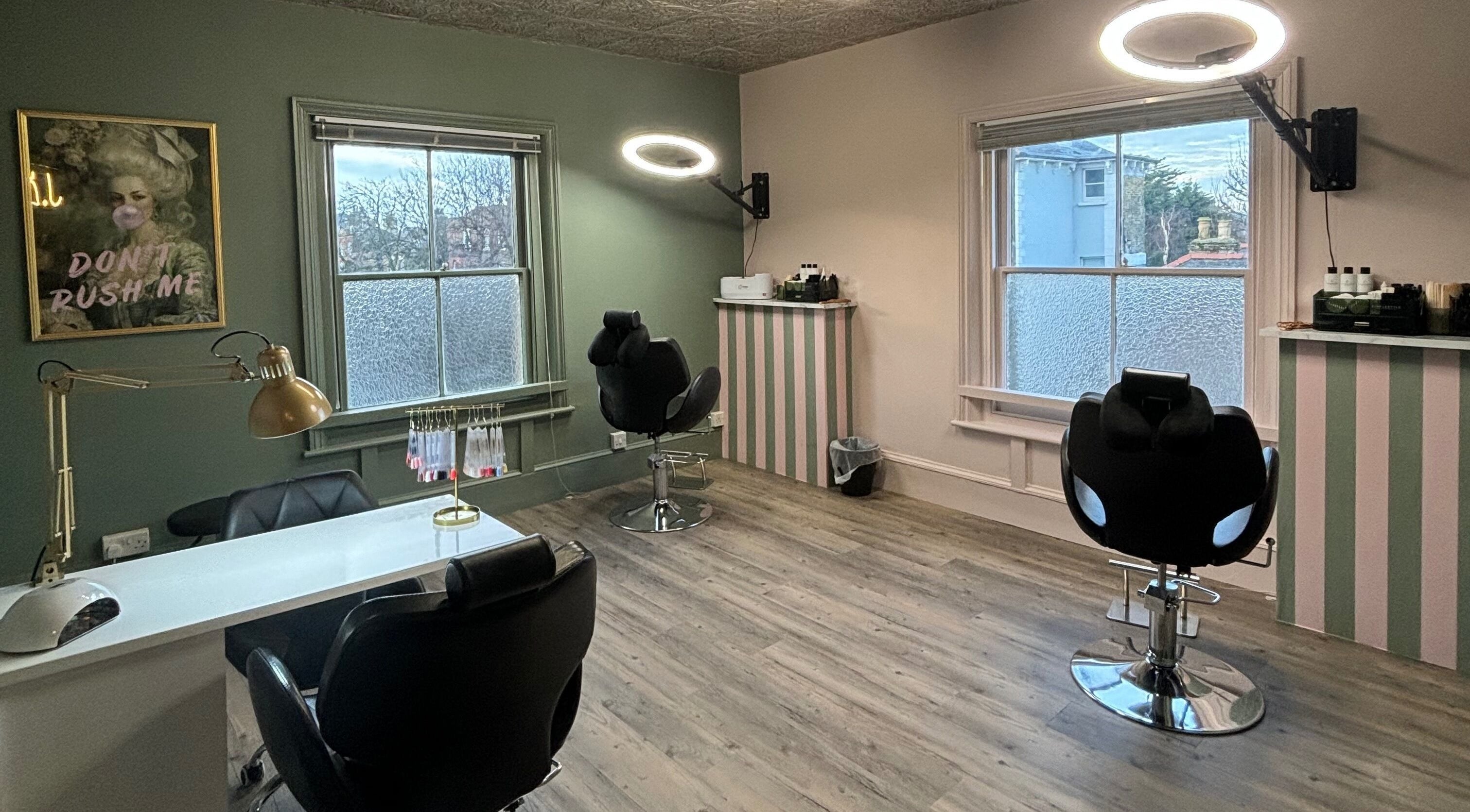 Cozy interior of JLR Brow & Beauty Bar in Deal, England, GB with stylish chairs and natural light.