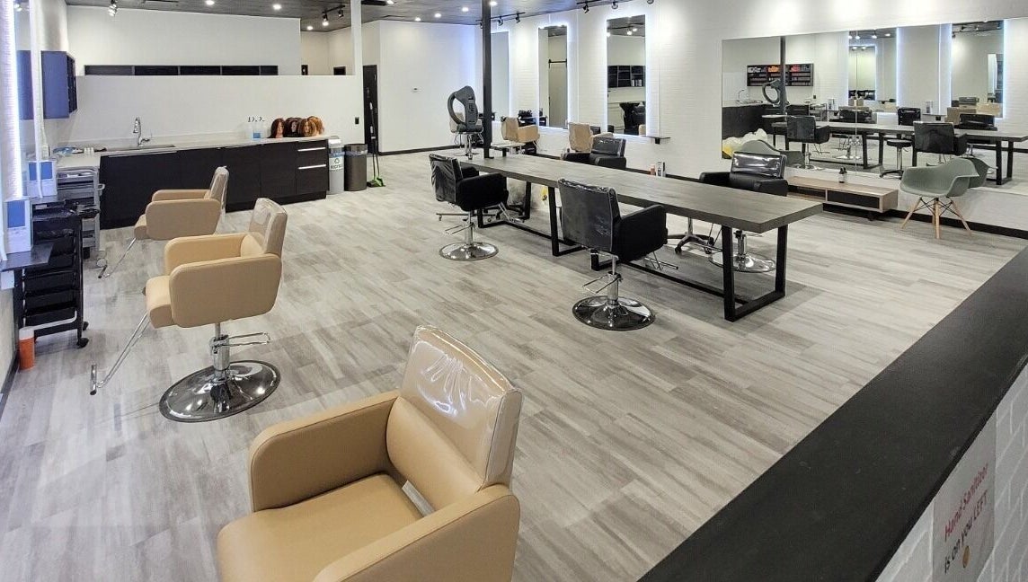 Modern interior of I'mk Hair Salon in Calgary, Alberta, CA with stylish chairs and mirrors.