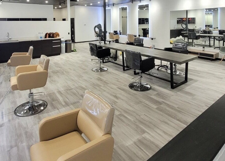 Modern interior of I'mk Hair Salon in Calgary, Alberta, CA with stylish chairs and mirrors.