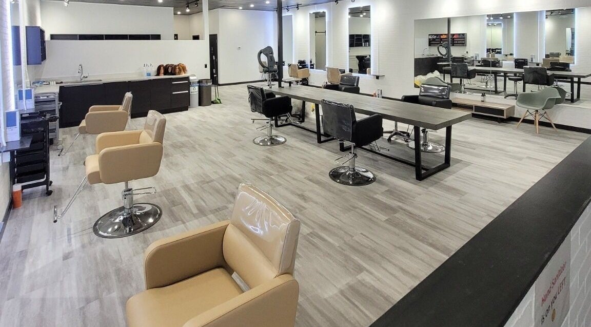 Modern interior of I'mk Hair Salon in Calgary, Alberta, CA with stylish chairs and mirrors.
