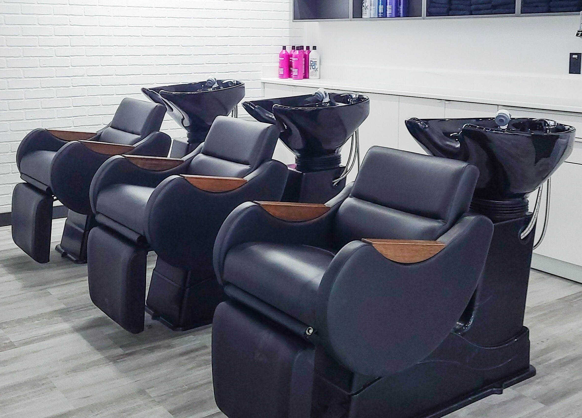 Modern wash stations at I'mk Hair Salon in Calgary, Alberta, CA offering a luxurious hair care experience.