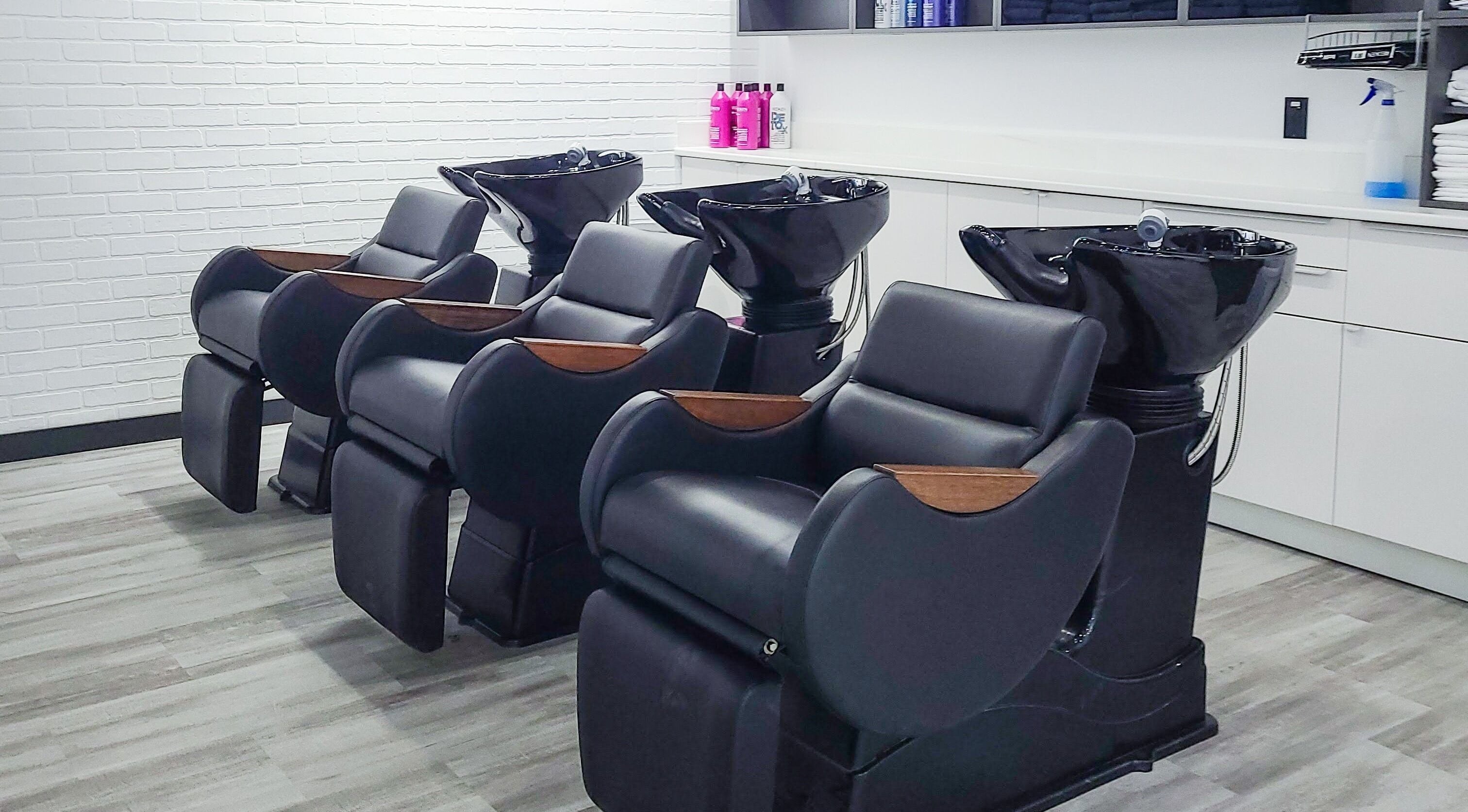 Modern wash stations at I'mk Hair Salon in Calgary, Alberta, CA offering a luxurious hair care experience.