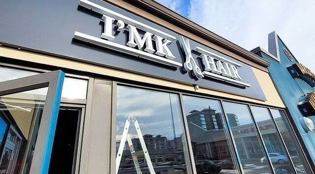 Exterior of I'mk Hair Salon in Calgary, Alberta, CA, showcasing modern design and welcoming entrance.