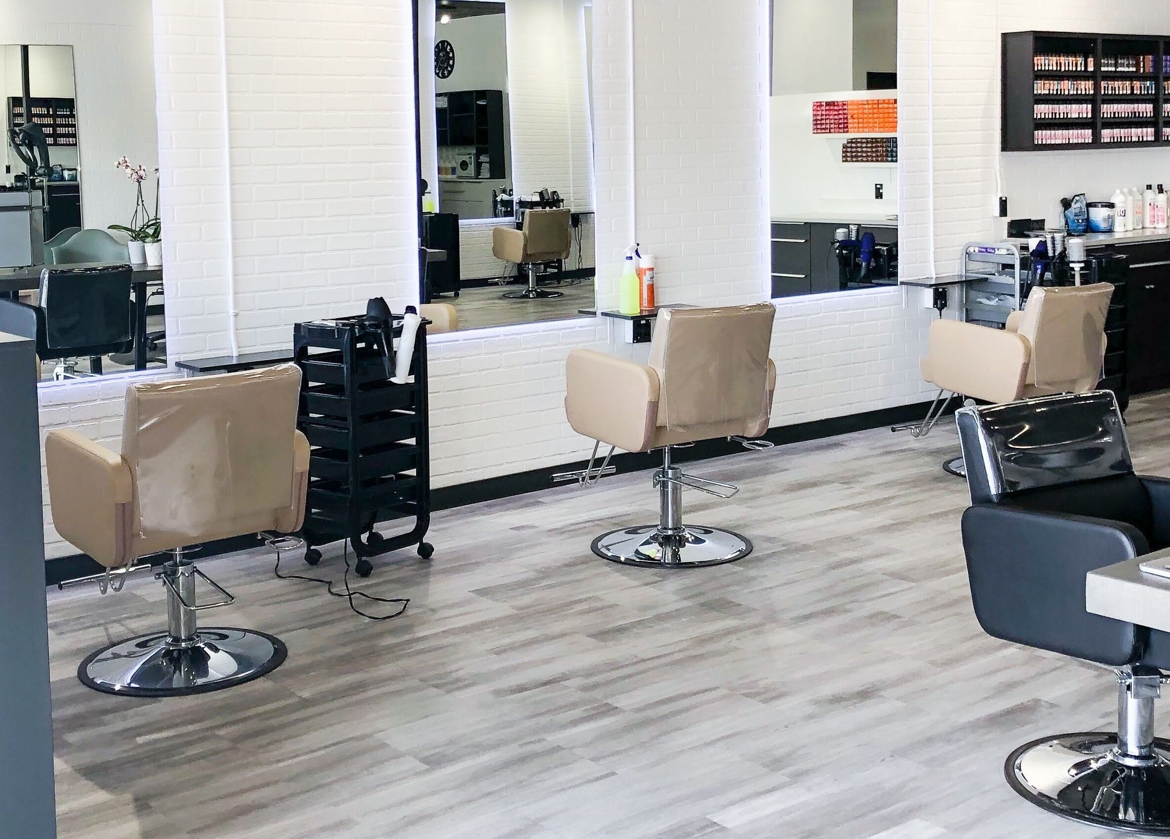 Modern interior of I'mk Hair Salon in Calgary, Alberta, CA with stylish chairs and mirrors.