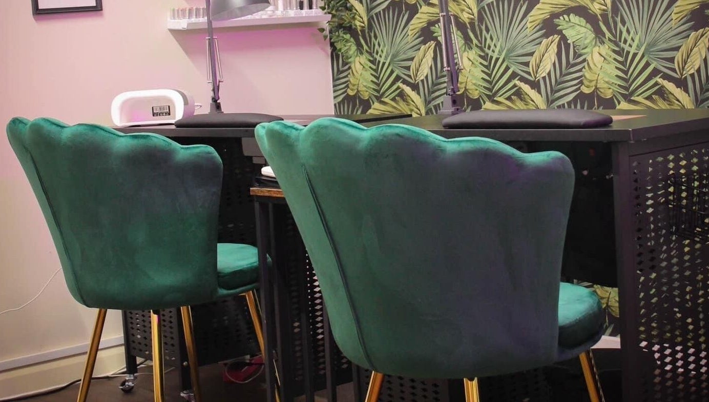 Chic green chairs against a tropical backdrop at Glow Beauty in Redhill, England, GB.