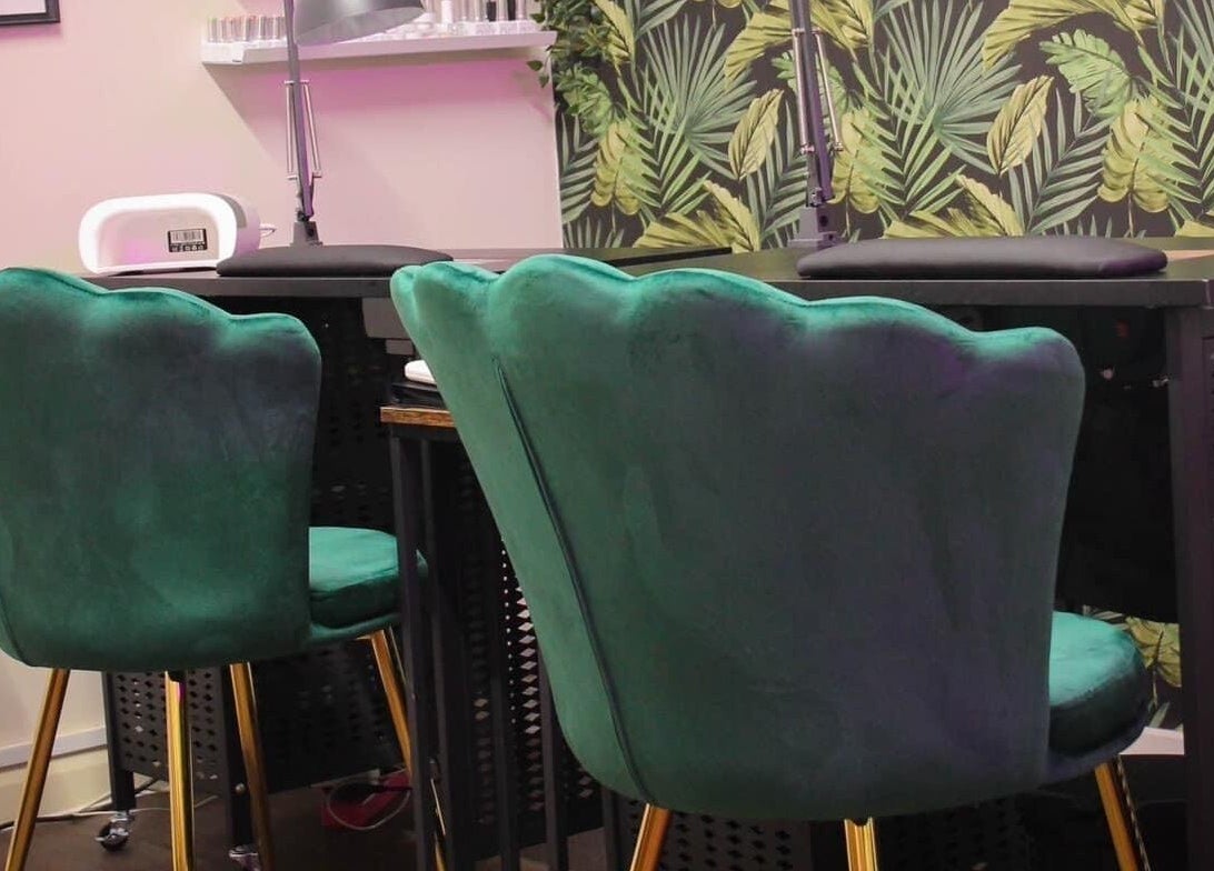 Chic green chairs against a tropical backdrop at Glow Beauty in Redhill, England, GB.