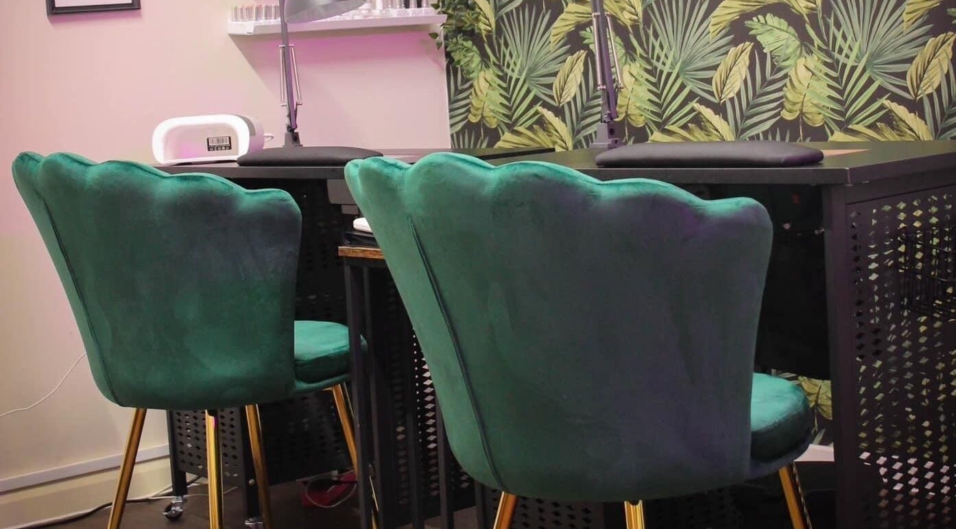 Chic green chairs against a tropical backdrop at Glow Beauty in Redhill, England, GB.