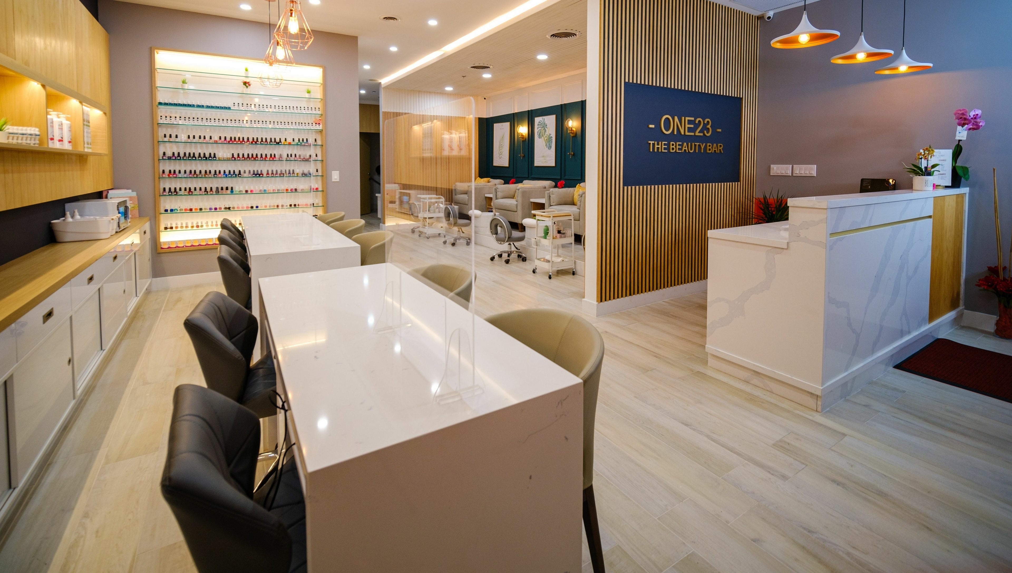 Modern interior of One23 Beauty Bar in Vaughan, Ontario, CA, showcasing chic manicure stations and elegant decor.